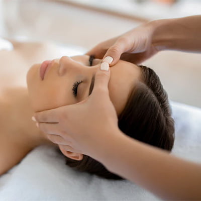 A woman enjoying a relaxing facial massage at a spa, rejuvenating her skin and indulging in self-care.